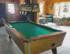 The inside of Twin Bay Resort Restaurant and Bar showing some of the tables and a pool table.