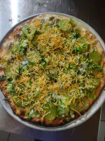 The Twin Bay Resort Twin Bay Mac Pizza, 1000 Island Dressing, Ground Chuck, Diced Onions, Pickles, Lettuce & Cheddar Cheese.