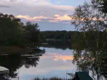 Outdoor picture during summetime showing Lake Nokomis and the clouds above during sunset.