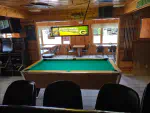 A view from inside the Twin Bay Resort Restaurant showing a pool table, some of the tables and part of the bar.